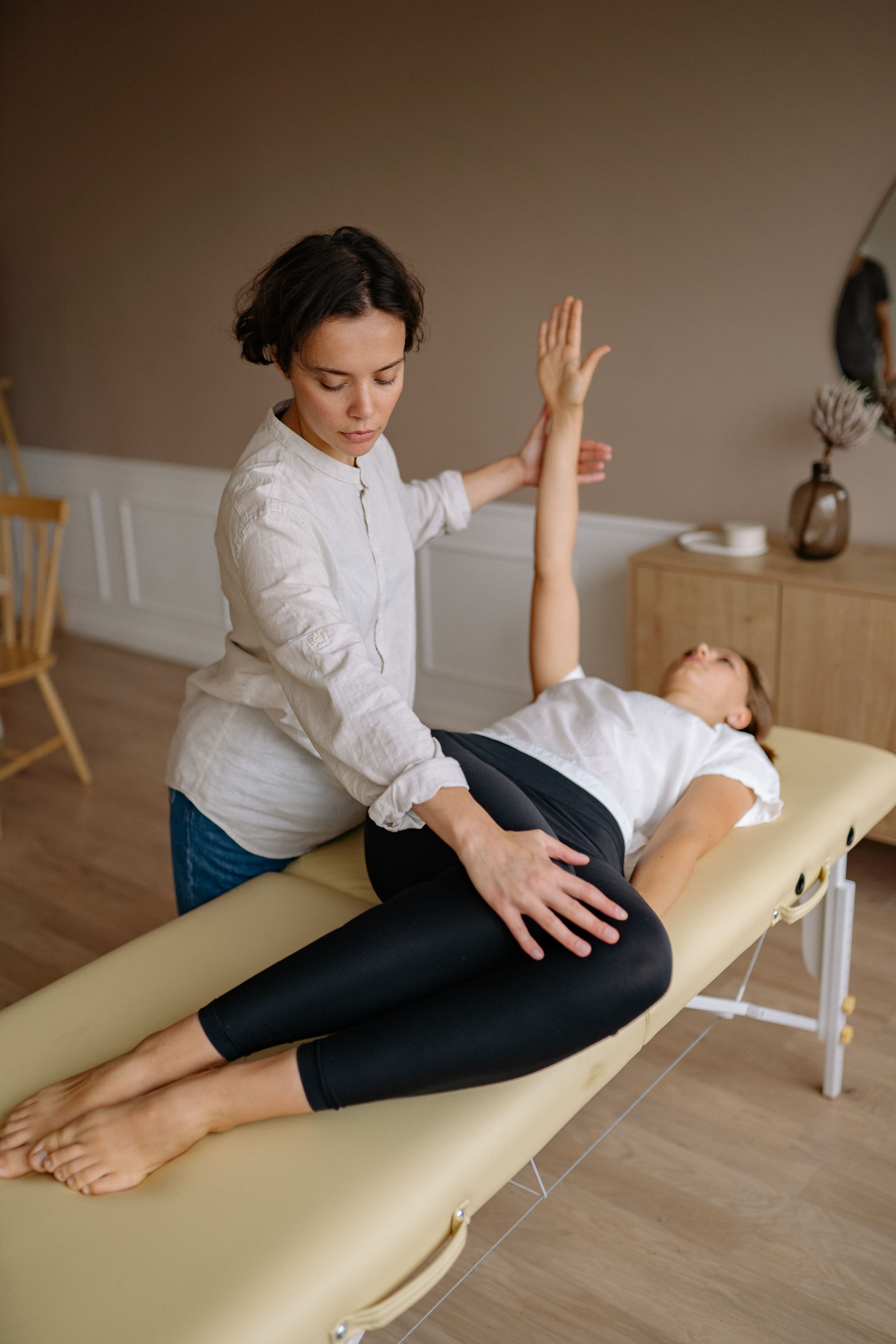 Physiotherapist treating a patient at home