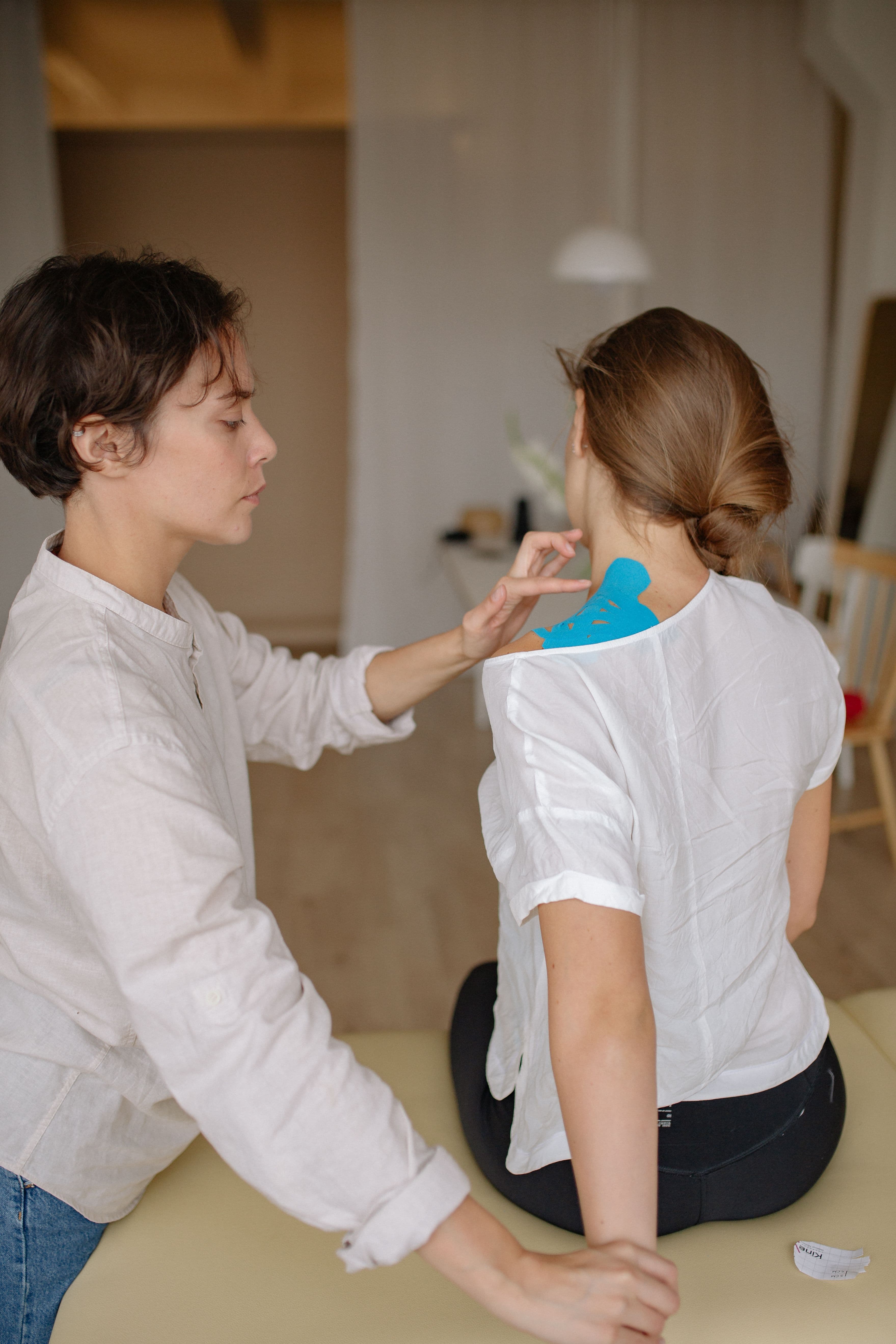A physiotherapist assisting a patient with a back stretch